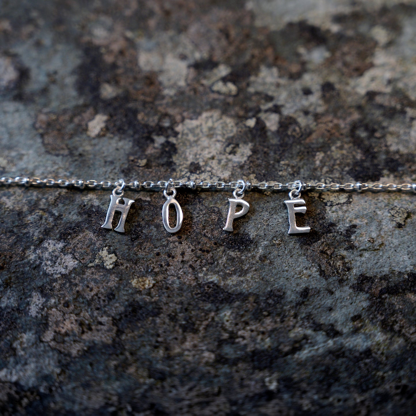 Silver hope bracelet on slate background