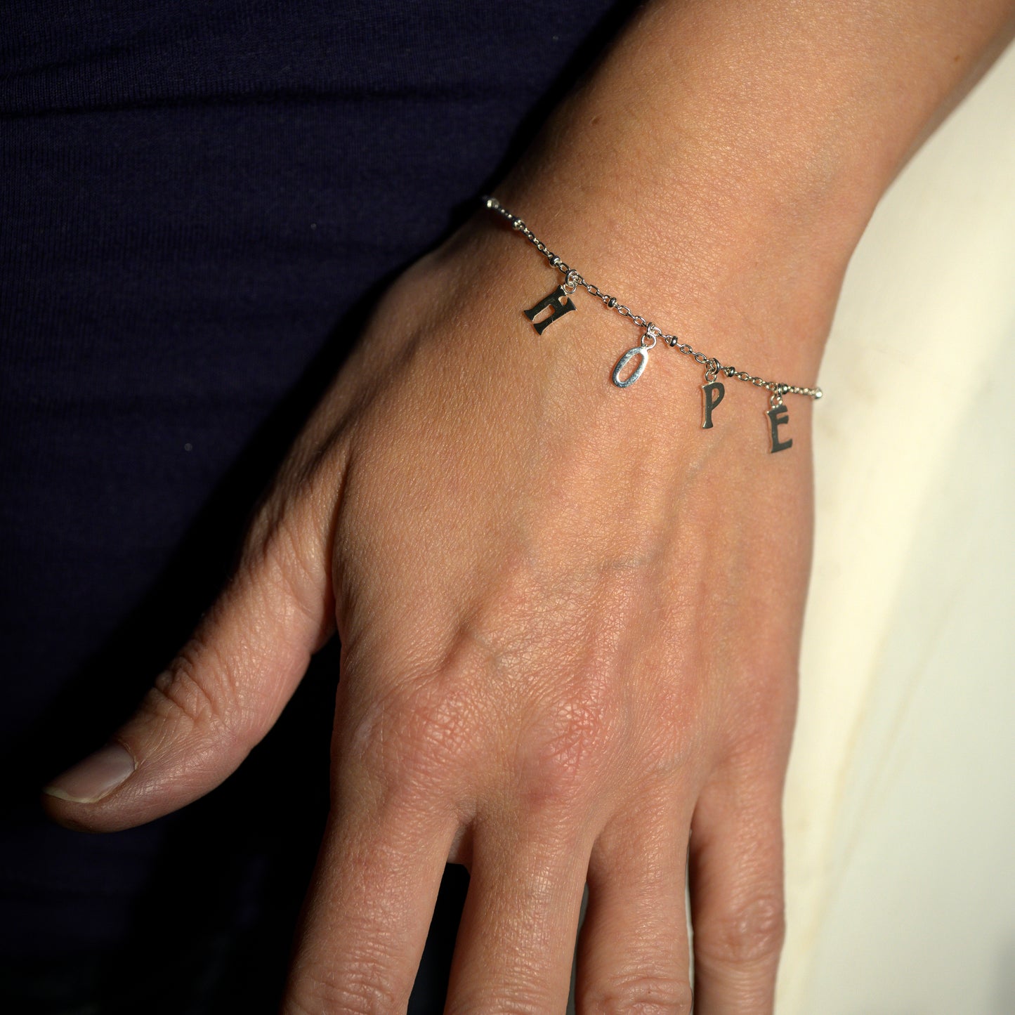 Silver hope bracelet on model's wrist