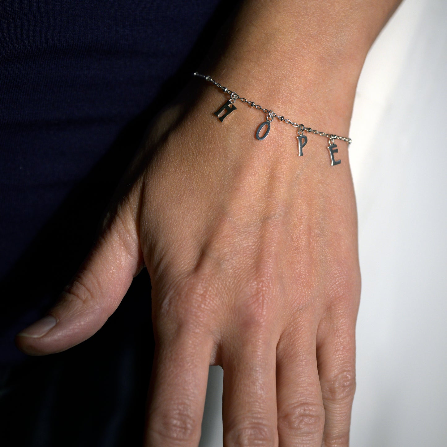 Silver hope bracelet on model's wrist