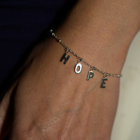 Silver hope bracelet on model's wrist