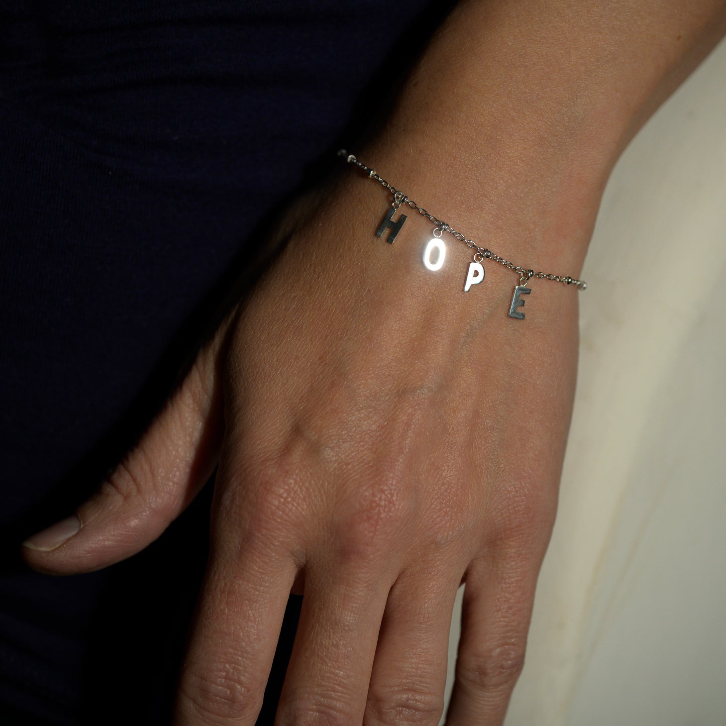 Silver hope bracelet on model's wrist