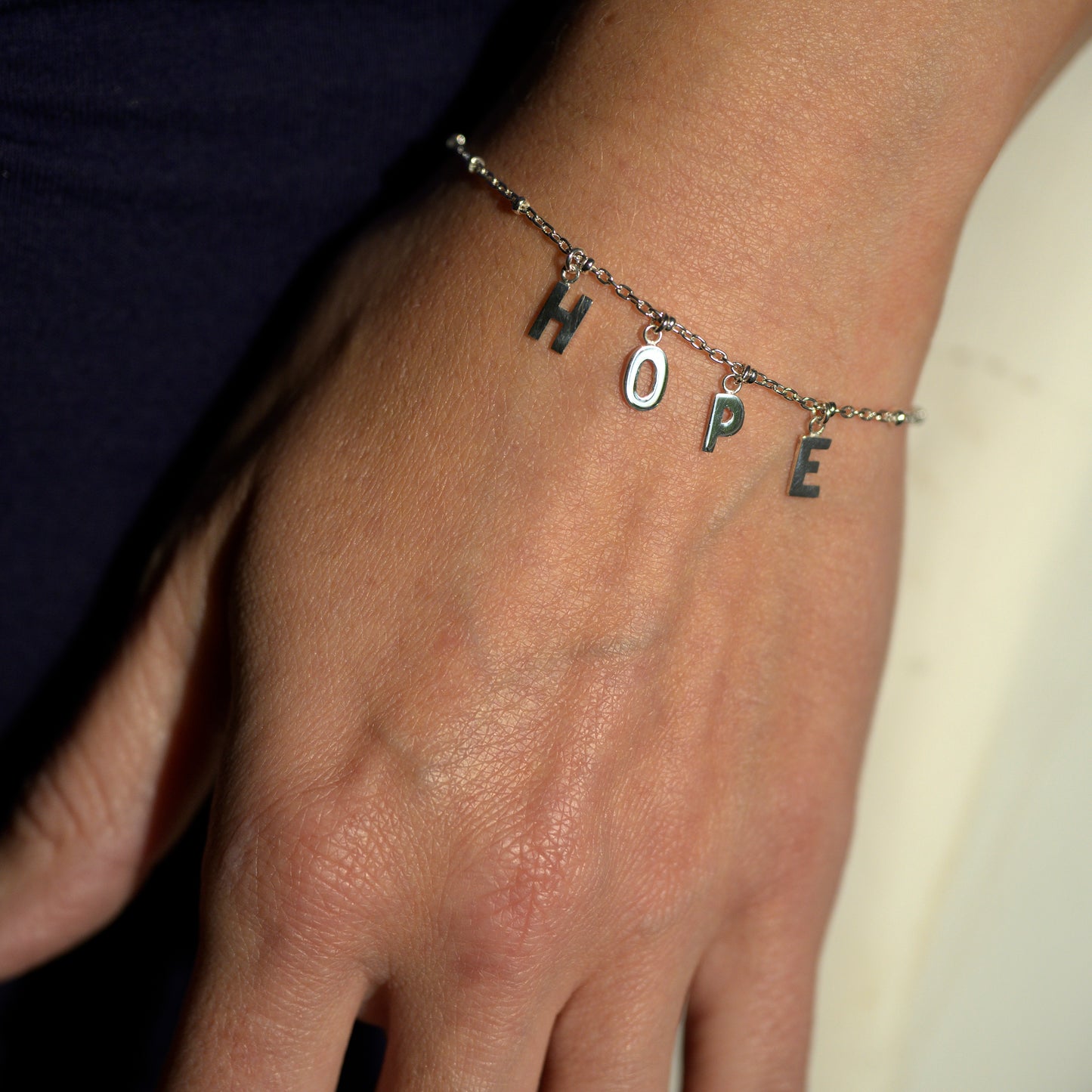 Silver hope bracelet on model's wrist