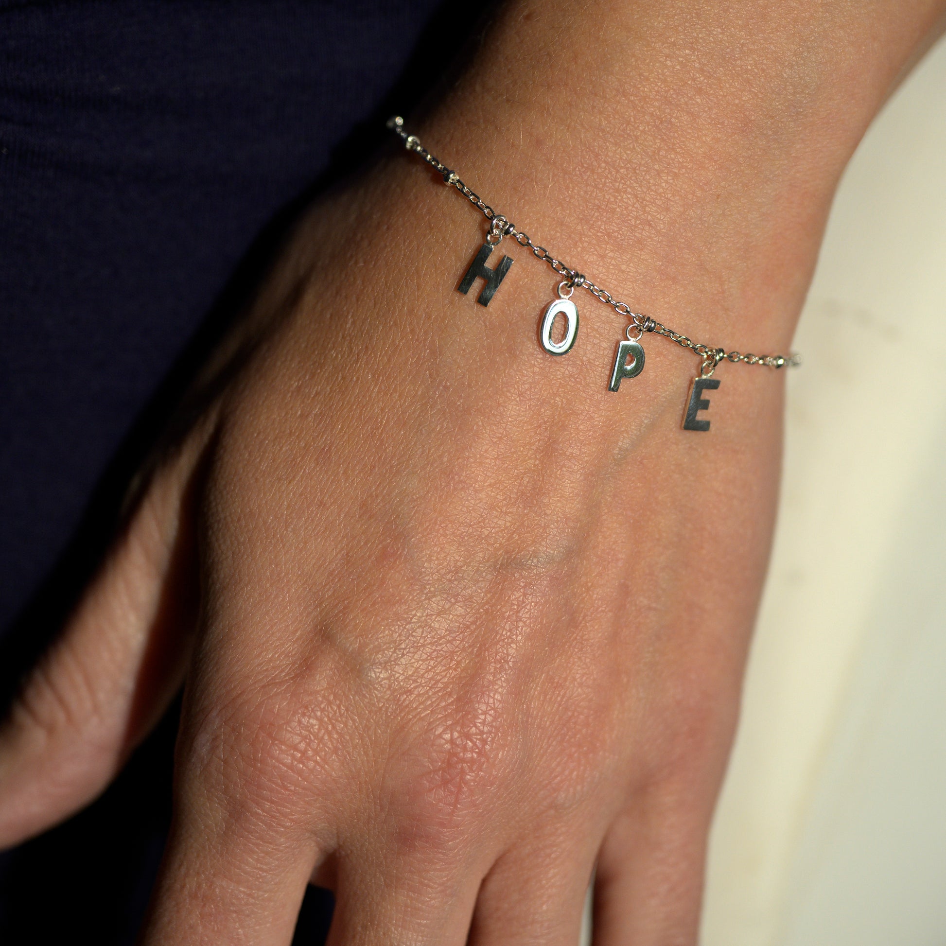 Silver hope bracelet on model's wrist
