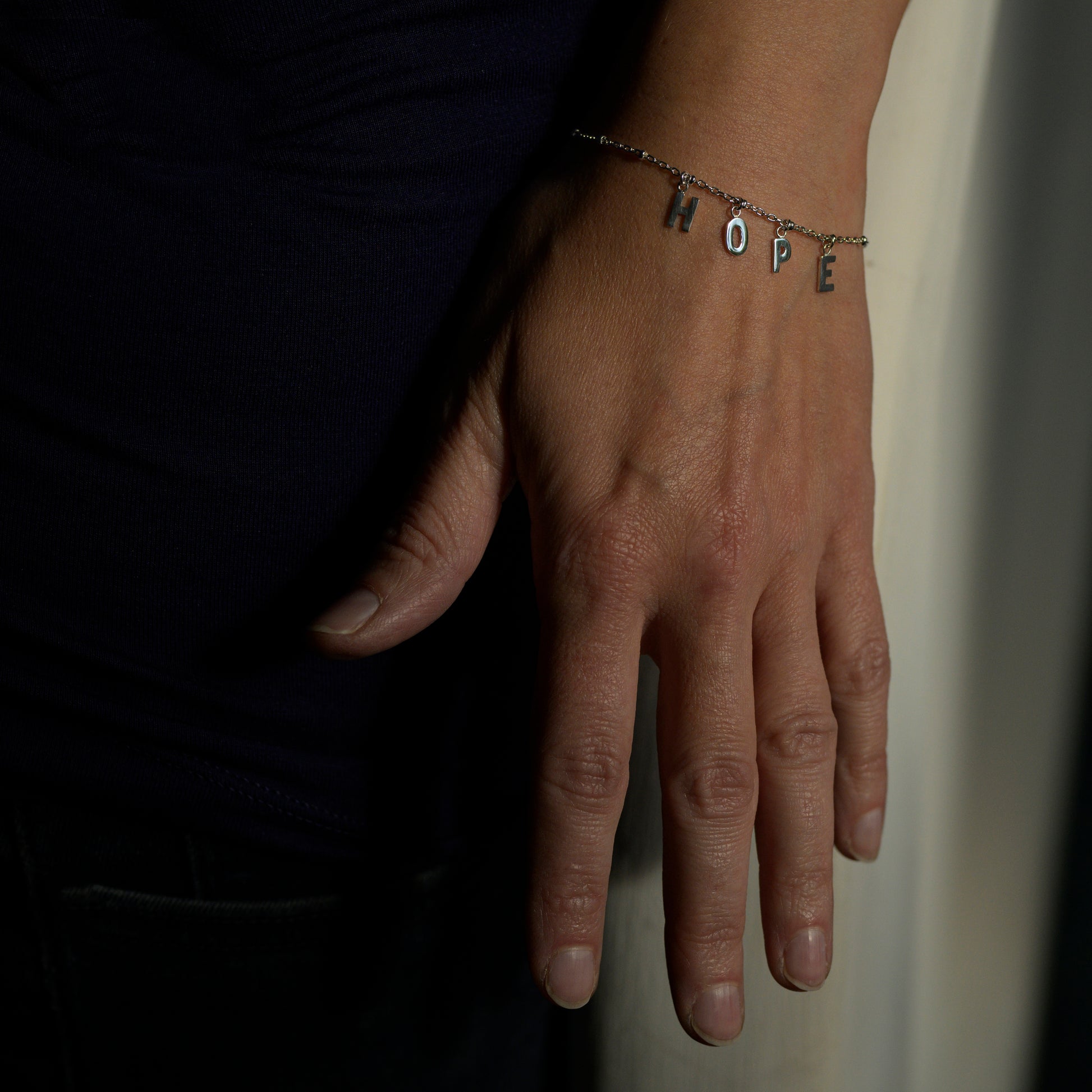 Silver hope bracelet on model's wrist
