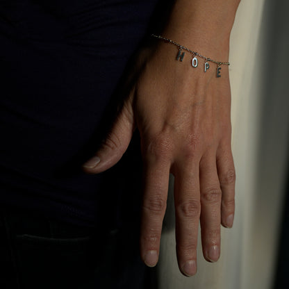 Silver hope bracelet on model's wrist
