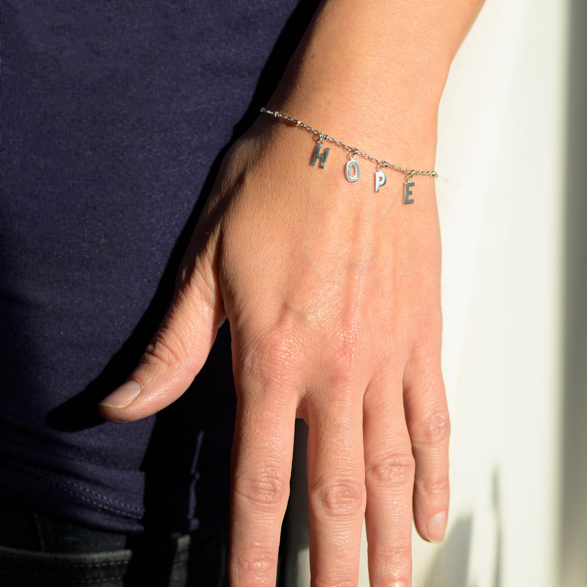 Silver hope bracelet on model's wrist