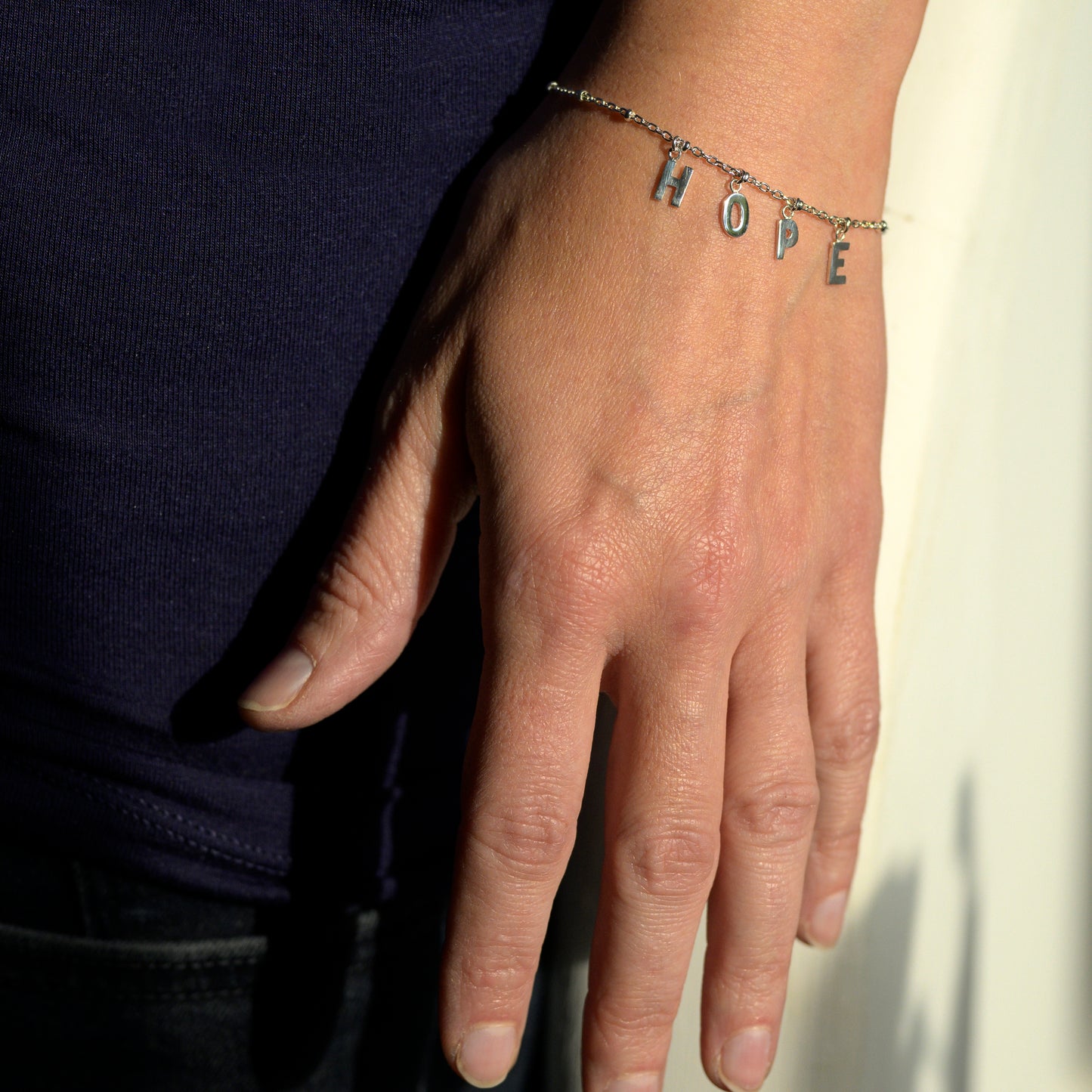 Silver hope bracelet on model's wrist