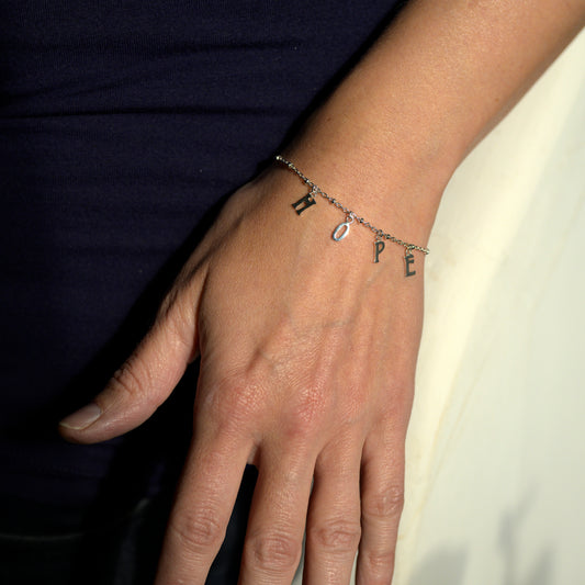 Silver hope bracelet on model's wrist