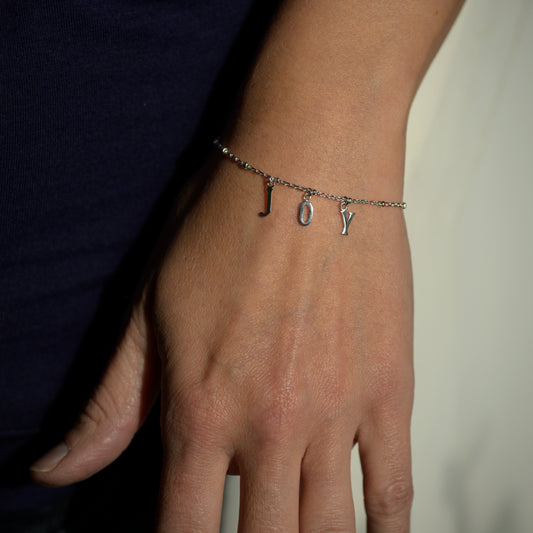 Silver joy bracelet on model's wrist