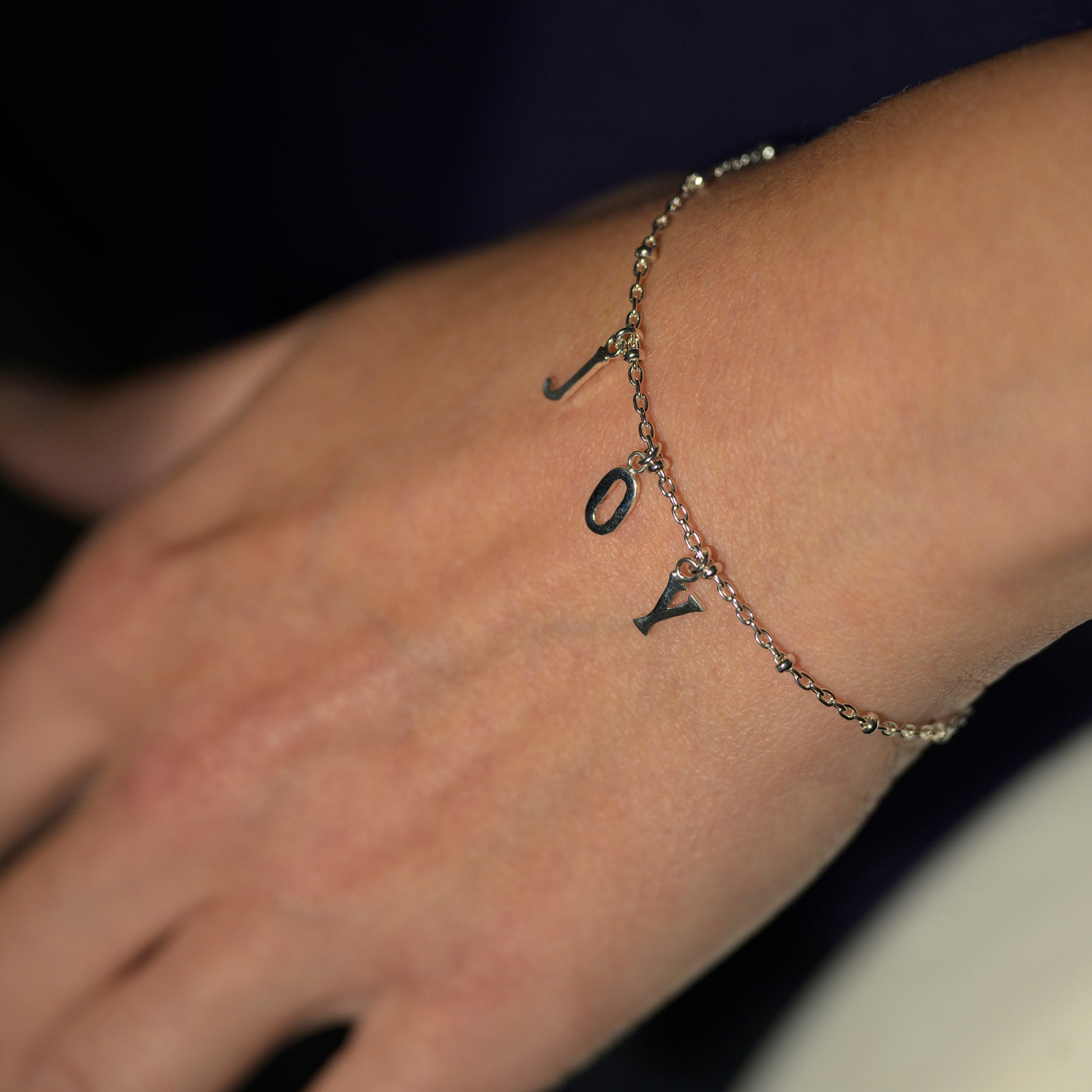 Silver joy bracelet on model's wrist