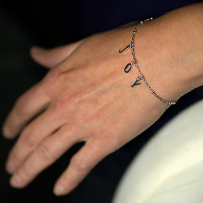 Silver joy bracelet on model's wrist