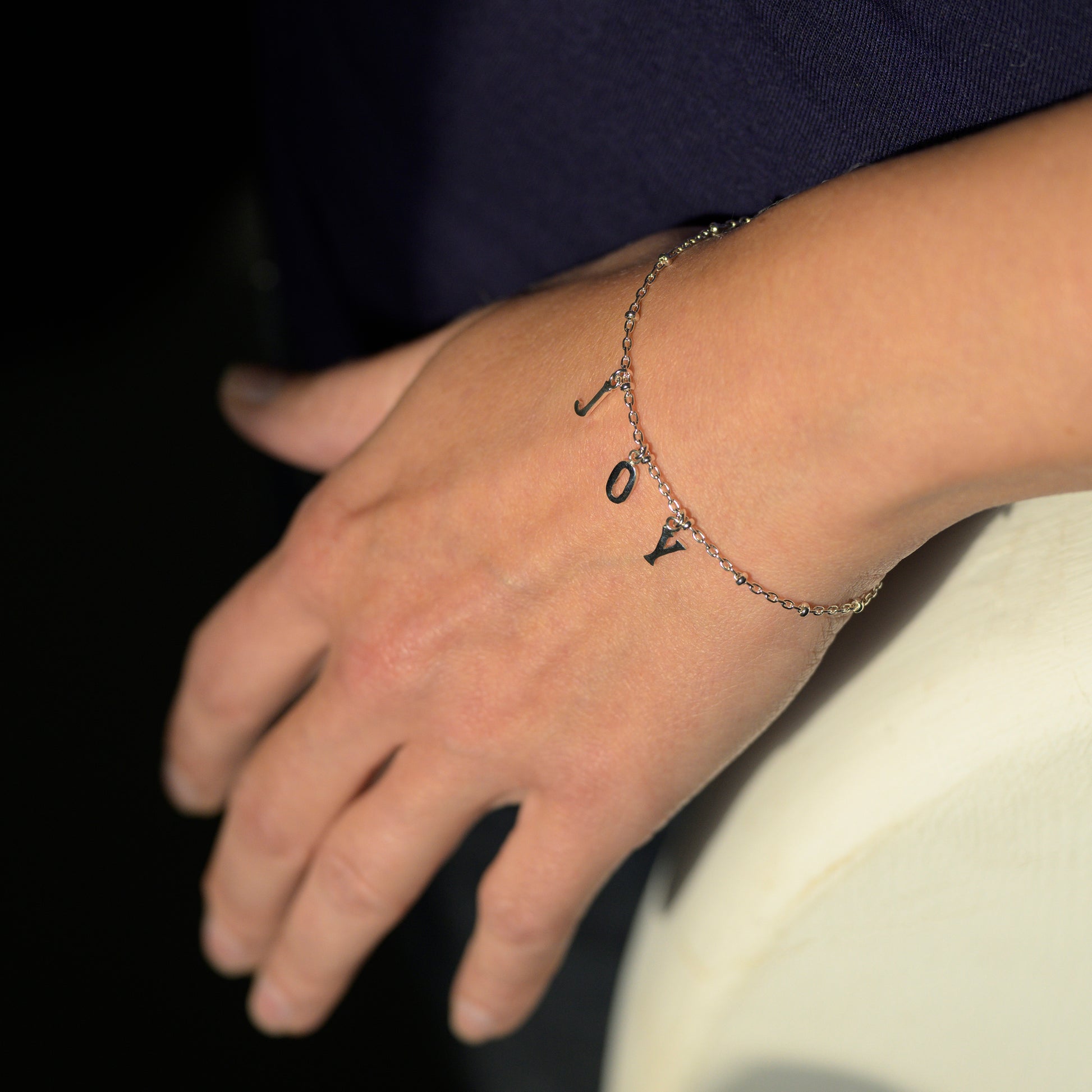 Silver joy bracelet on model's wrist