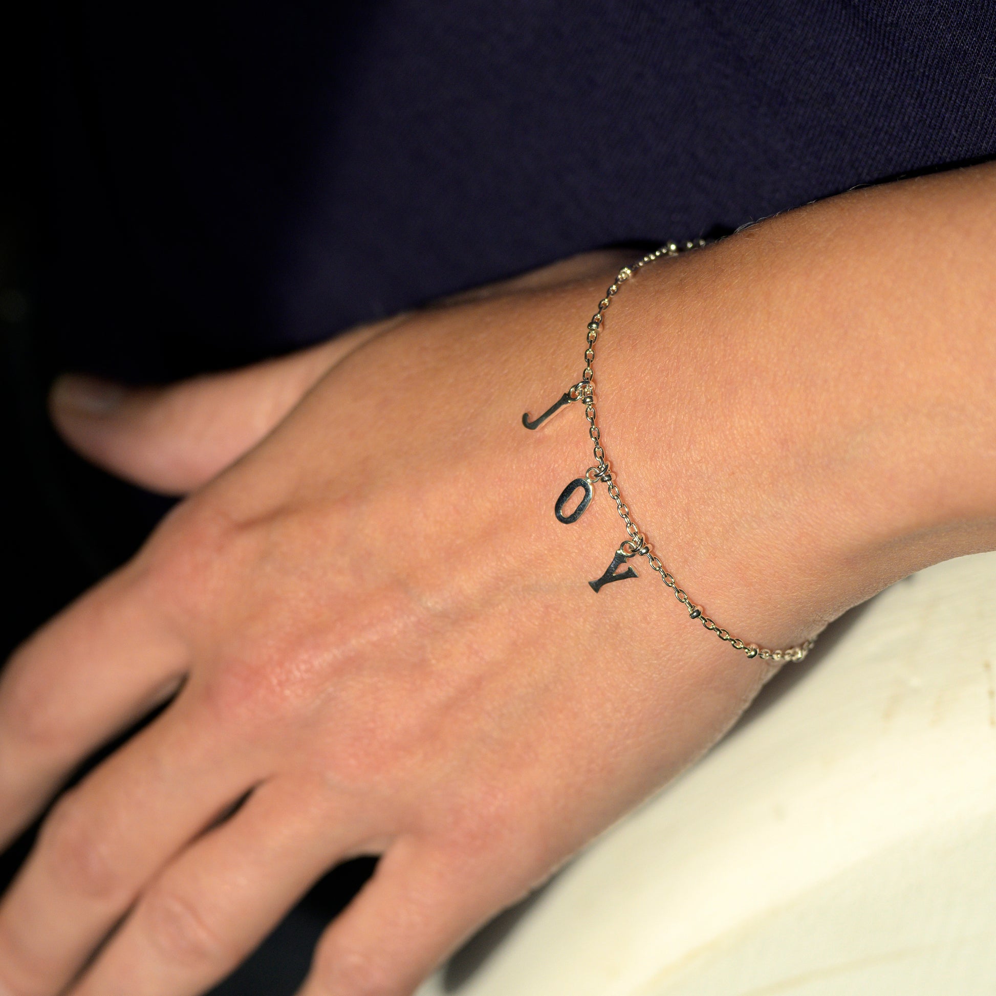 Silver joy bracelet on model's wrist
