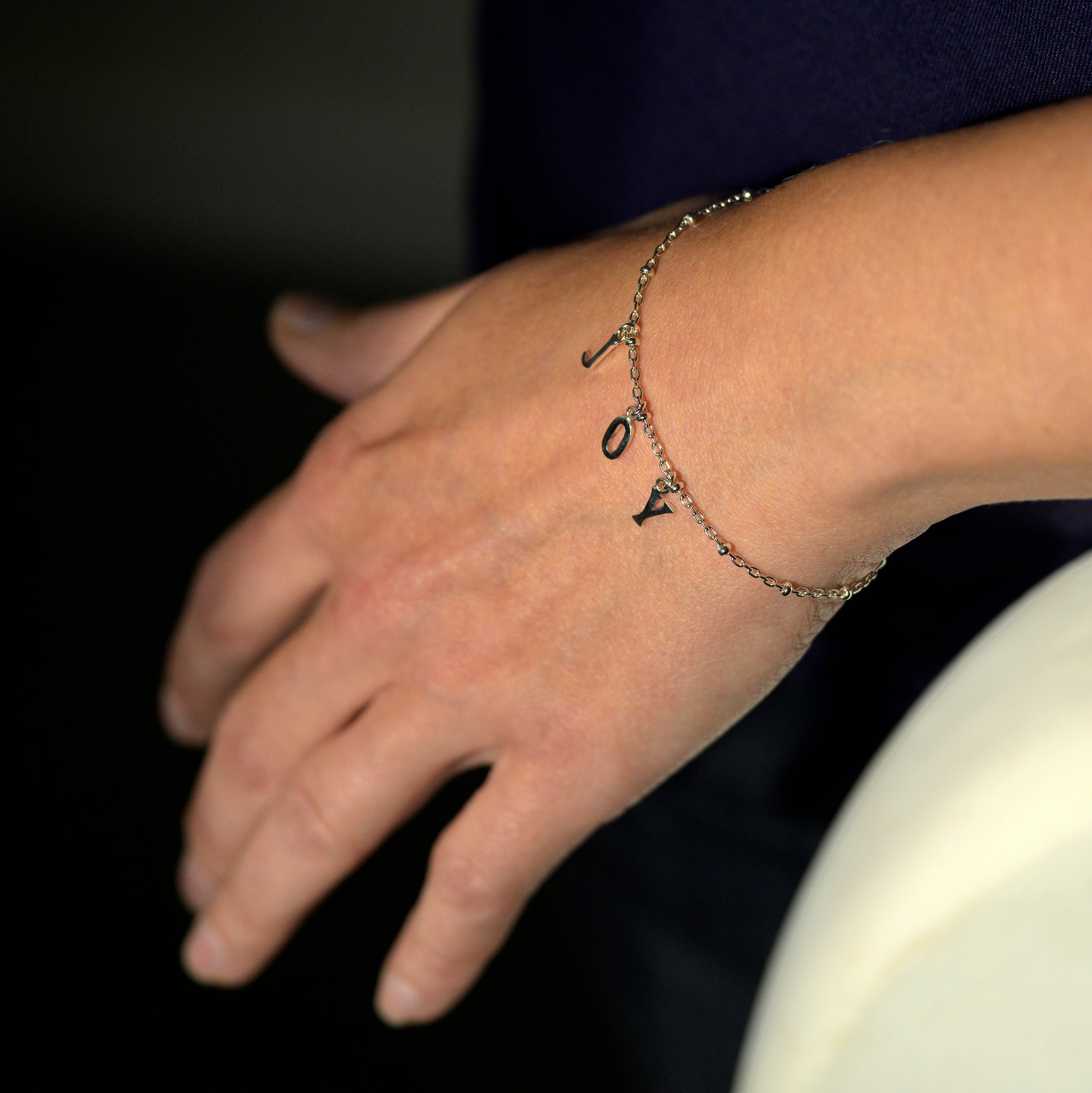 Silver joy bracelet on model's wrist