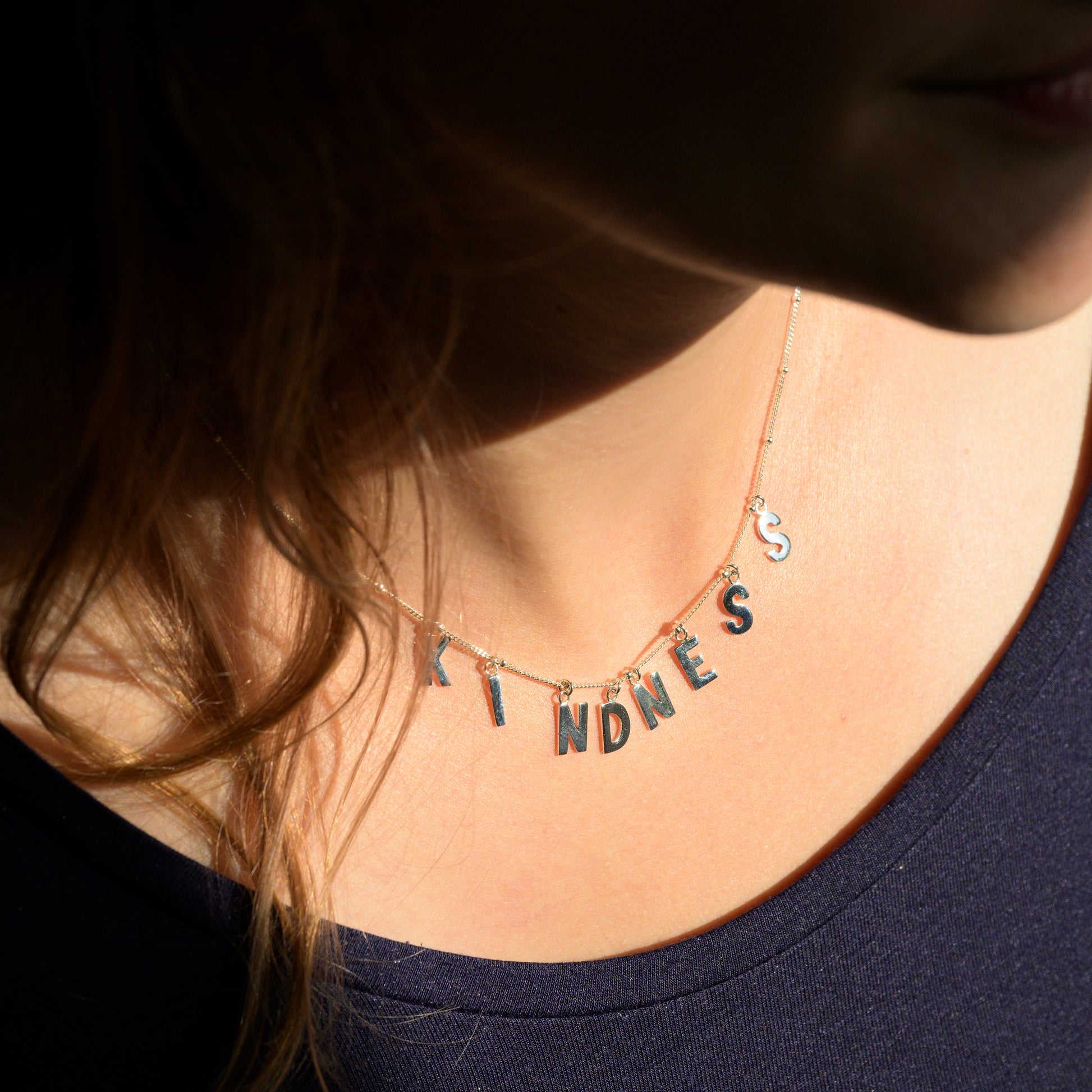 Silver Kindness necklace on model's neck
