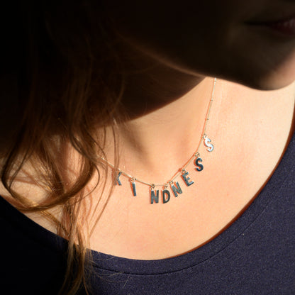 Silver Kindness necklace on model's neck