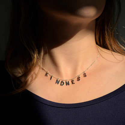 Silver Kindness necklace on model's neck