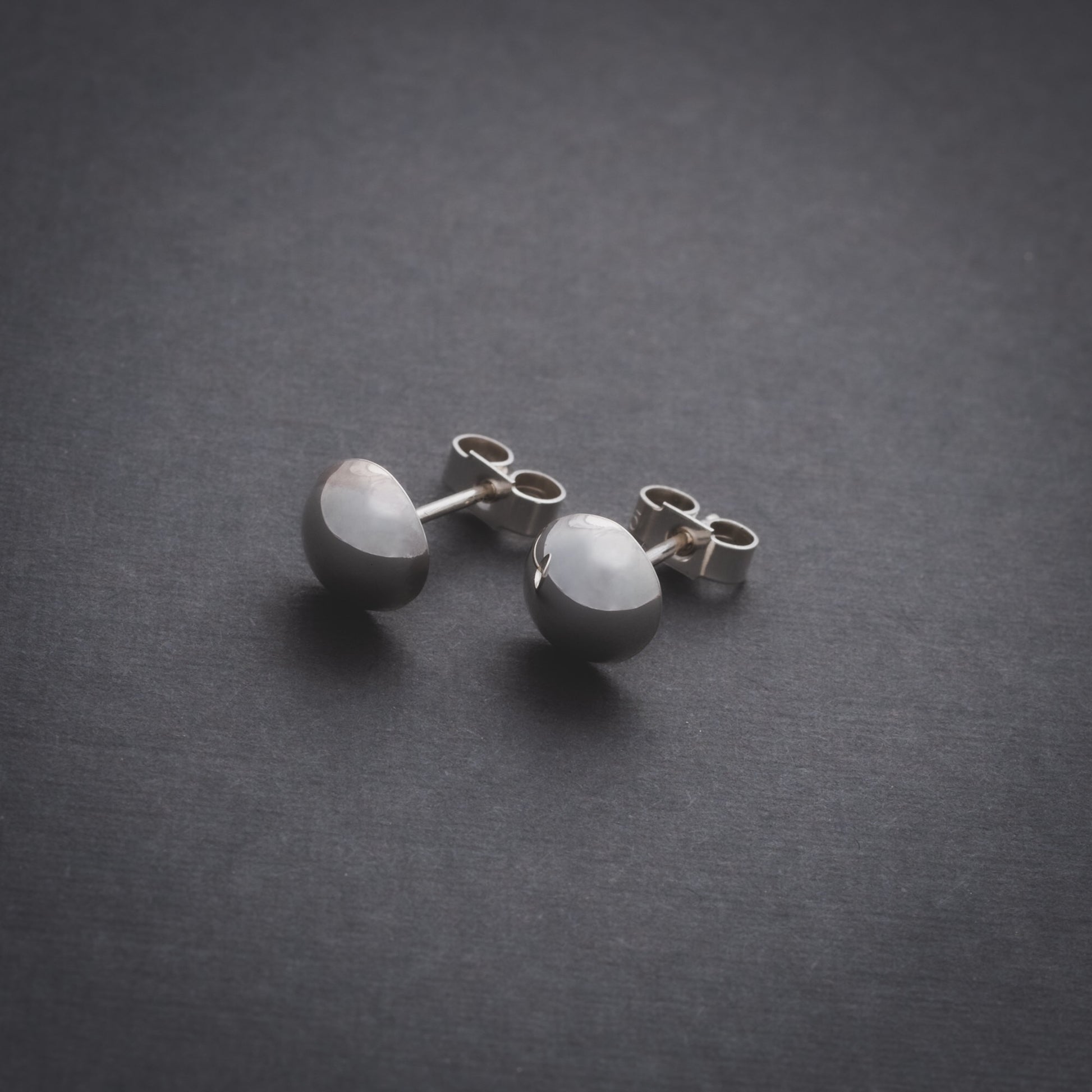 Product shot of silver domed stud earrings
