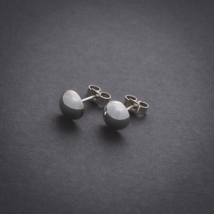 Product shot of silver domed stud earrings